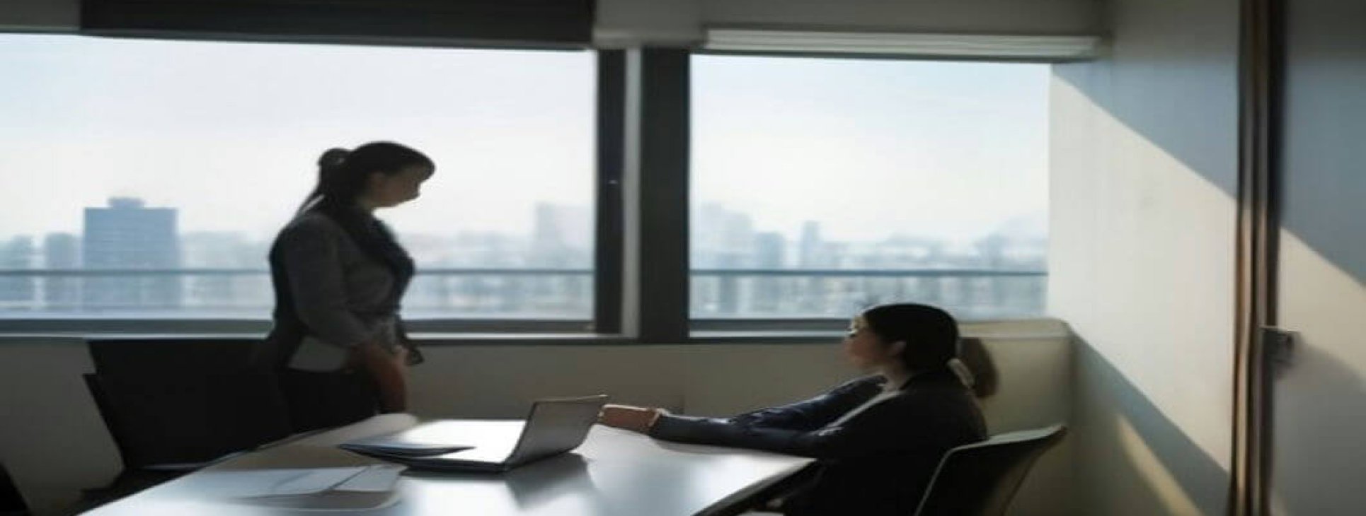 Business professionals comparing EOR vs local entity Israel costs over a contract in a Tel Aviv office