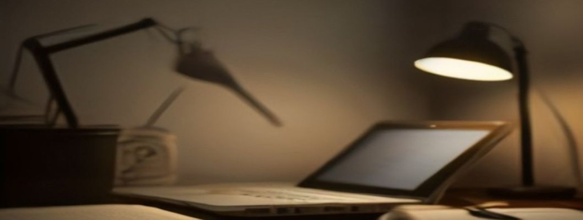 Israeli employee working on freelance side income compliance at a home desk in the evening