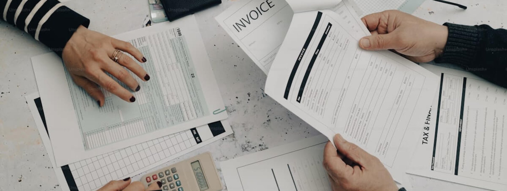 Business professionals reviewing payroll and finance documents for Israel payroll services