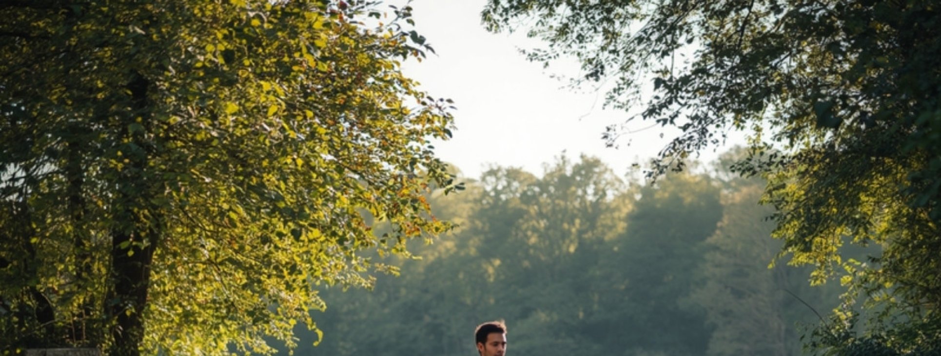 Person walking outdoors with a laptop, considering career options